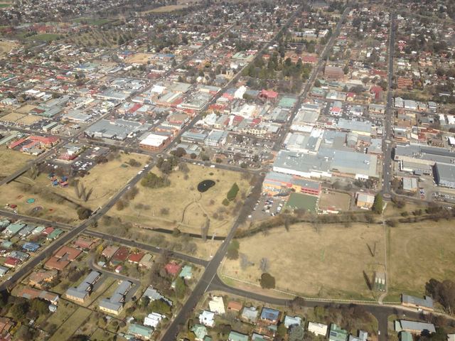 Aerial view of Armidale's city centre and the Dumaresq Creek parkland on a dry winter day.