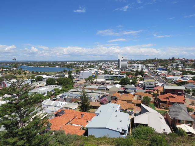 View over Bunbury's rooftops and city centre from Marlston Hill Lookout, with water and the coast in the distance.