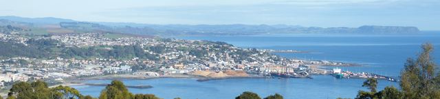 Panorama of Burnie and its port on the coast, seen from the hills above town.
