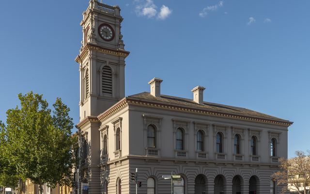 The Castlemaine Post Office with its tall clock tower under a blue sky.