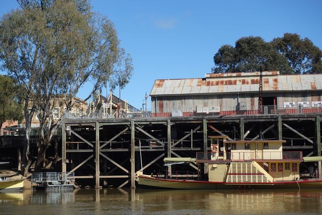 A paddle steamer moored at the tall timber Echuca Wharf on the Murray River.