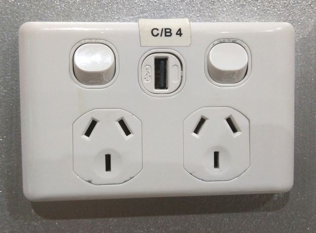 A white Australian double power point with a USB charging port between the two switches.